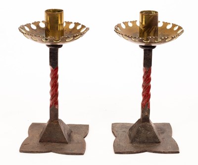 Lot 941 - A pair of painted red wrought iron and brass...