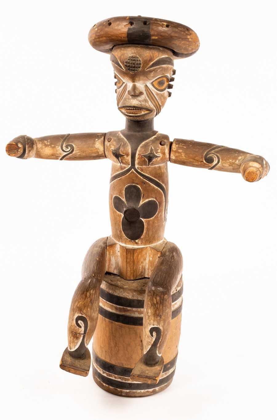 Lot 962 - A carved and painted tribal figure modelled...