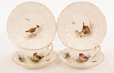Lot 31 - A pair of tea cups and saucers painted birds...