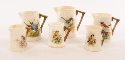 Lot 43 - Six Royal Worcester ribbed jugs, painted birds,...
