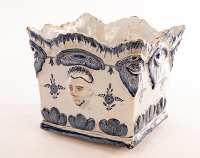 Lot 75 - A Delft square planter with moulded mask heads...