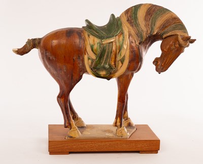 Lot 100 - A Chinese sancai glazed horse on plinth, 20th...