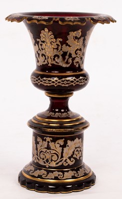 Lot 116 - A 19th Century cranberry glass pedestal urn,...