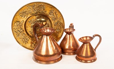 Lot 309 - A graduated set of three copper measures, half...