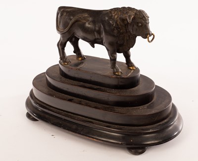 Lot 347 - A bronze figure of a bull on a stepped oval...