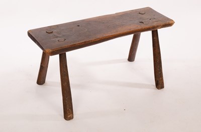 Lot 407 - A rectangular rustic elm stool on splay...