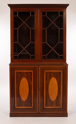 Lot 459 - An Edwardian mahogany bookcase, the two glazed...