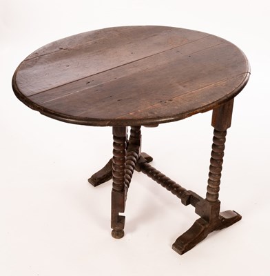 Lot 461 - A Charles II oak coaching table, with oval tip-...