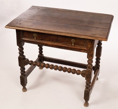 Lot 479 - A William and Mary oak side table, the planked...