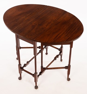 Lot 500 - An oval two-flap table on turned legs with pad...