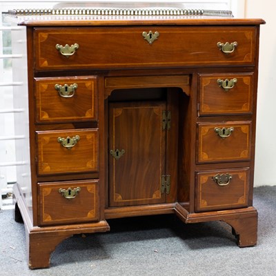 Lot 502 - A George III mahogany and inlaid kneehole desk...