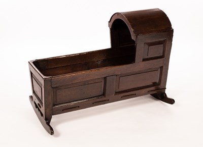 Lot 510 - An oak cradle with an arch top hood and...