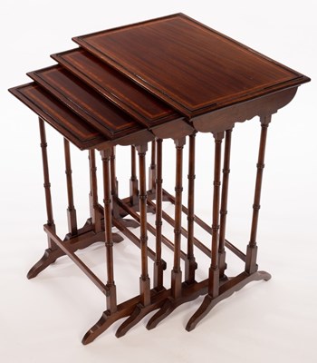 Lot 515 - A nest of four mahogany tables banded in...