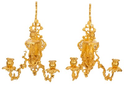 Lot 560 - A pair of French re-gilded metal wall lights,...