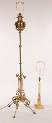 Lot 562 - A brass telescopic standard lamp on four splay...