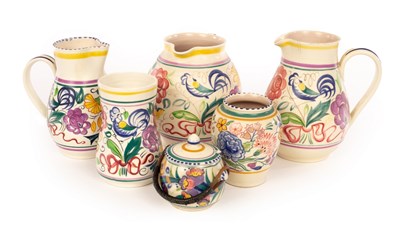 Lot 228 - Poole Pottery, three floral jugs, the tallest...