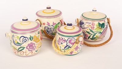 Lot 230 - Poole Pottery, four floral biscuit barrels,...