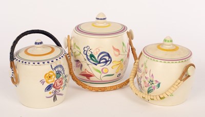 Lot 232 - Poole Pottery, three floral biscuit barrels...