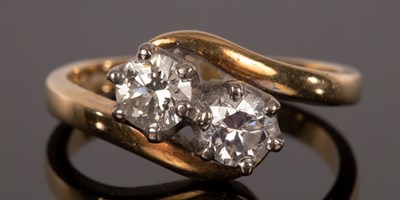 Lot 395 - A diamond crossover ring, the two stones each...