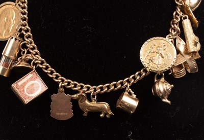 Lot 398 - A 9ct yellow gold charm bracelet hung with a...