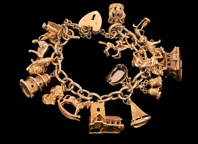 Lot 407 - A 9ct yellow gold charm bracelet, the curb...