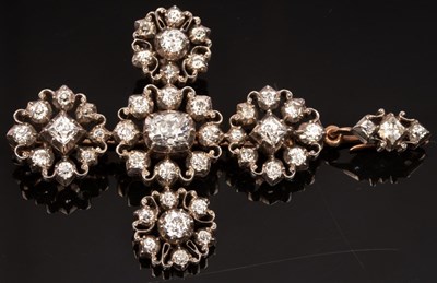 Lot 414 - A diamond pendant/brooch of cross form, the...