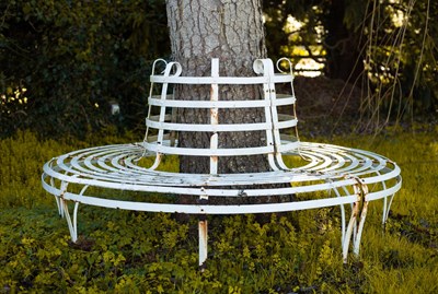 Lot 500 - A wrought iron circular slatted tree seat,...