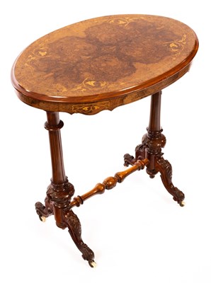 Lot 547 - A Victorian walnut table, the oval inlaid top...