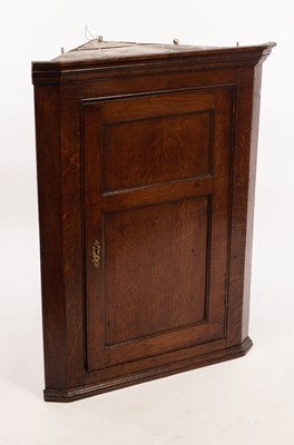 Lot 556 - A 19th Century oak corner cupboard enclosed by...