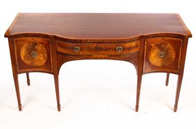 Lot 566 - A mahogany serpentine front sideboard, cross...