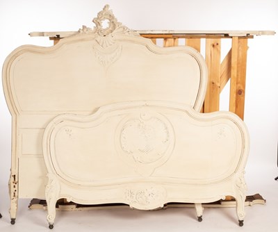 Lot 568 - A 4'6'' white painted bedstead with carved...