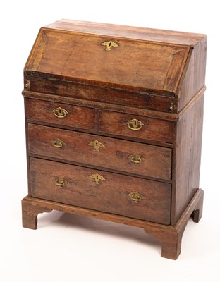 Lot 571 - An early 18th Century oak bureau of small...