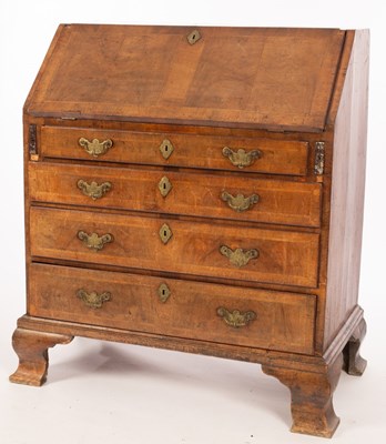 Lot 584 - A George II walnut bureau, with sloping flap...