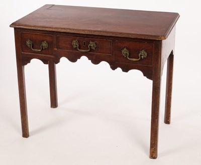 Lot 595 - A George III mahogany lowboy fitted three...