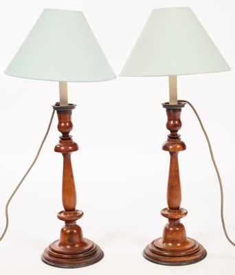 Lot 632 - A pair of turned fruitwood candlesticks with...