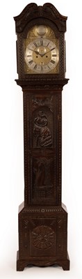 Lot 671 - A carved oak cased longcase clock, the dial...