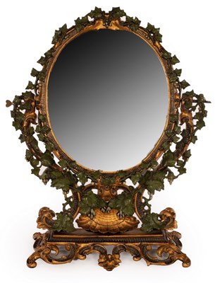 Lot 708 - A metal swing frame mirror decorated ivy...