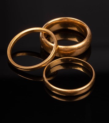 Lot 127 - Two 22ct gold wedding bands, sizes K and N,...