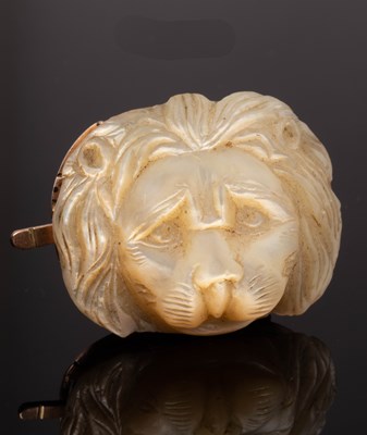 Lot 135 - A carved mother-of-pearl lion mask, mounted as...