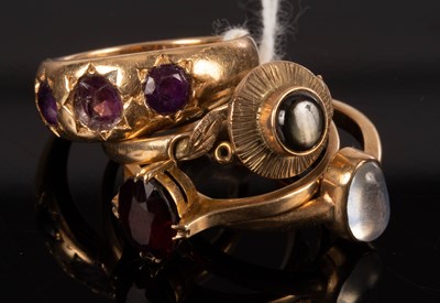 Lot 143 - An amethyst three-stone ring set in 18ct gold,...