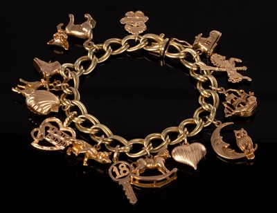 Lot 161 - An Italian 14k yellow gold charm bracelet hung...