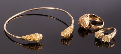 Lot 164 - A 14k gold torc bangle with lion mask...