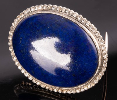 Lot 176 - A lapis lazuli and diamond brooch, the oval...