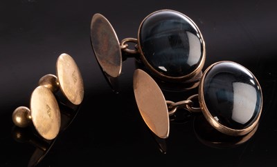 Lot 182 - A pair of cat's eye cabochon cufflinks, set in...