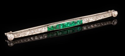 Lot 199 - An emerald and diamond bar brooch set with a...