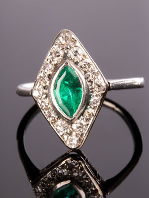 Lot 203 - An emerald and diamond cluster ring, the...