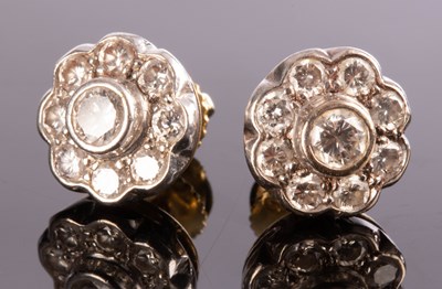 Lot 214 - A pair of diamond cluster ear studs, each nine-...