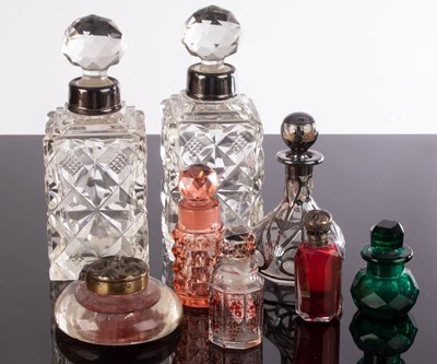 Lot 251 - A pair of cut glass scent bottles with silver...