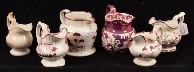 Lot 278 - Six pink lustre jugs with various decoration,...