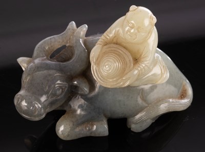 Lot 383 - A Chinese grey jade, carved as a boy on the...